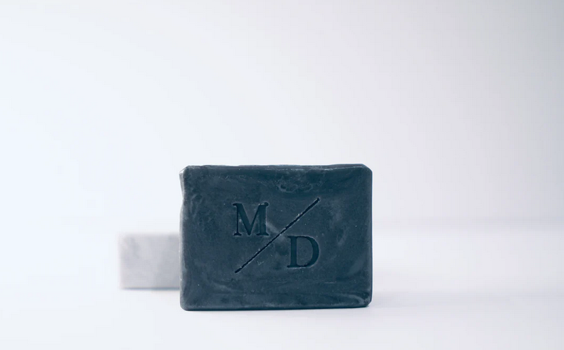 Bar of soap with 'M D' branding on a white background
