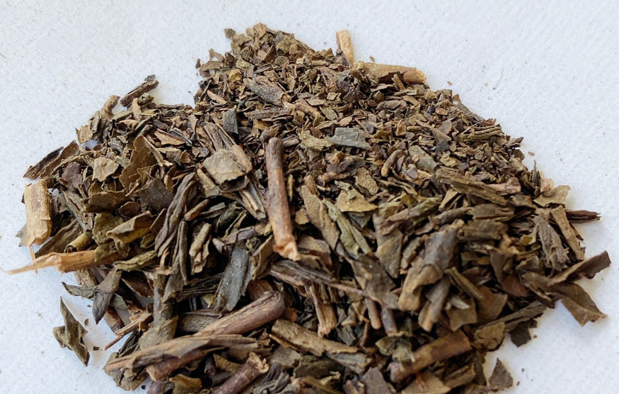 A pile of hoji-cha tea on a plain background.