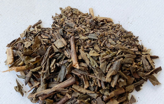 A pile of hoji-cha tea on a plain background.