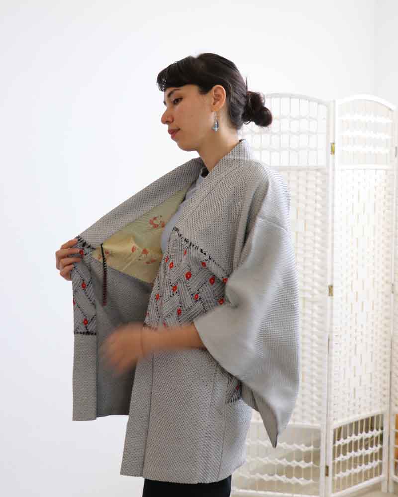 Photo of  a woman opening the kimono.