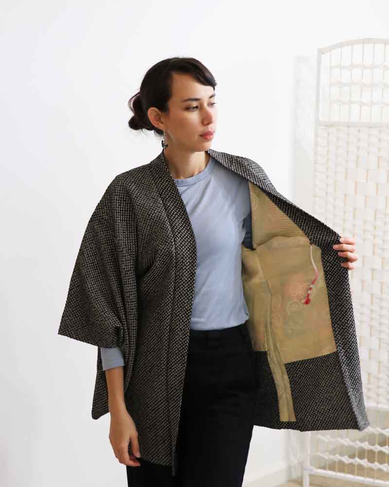 Photo of  a woman opening the kimono.