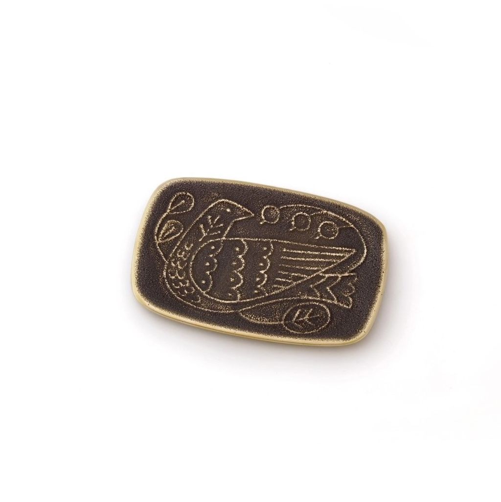 Bronze-colored metal badge with intricate design on a white background