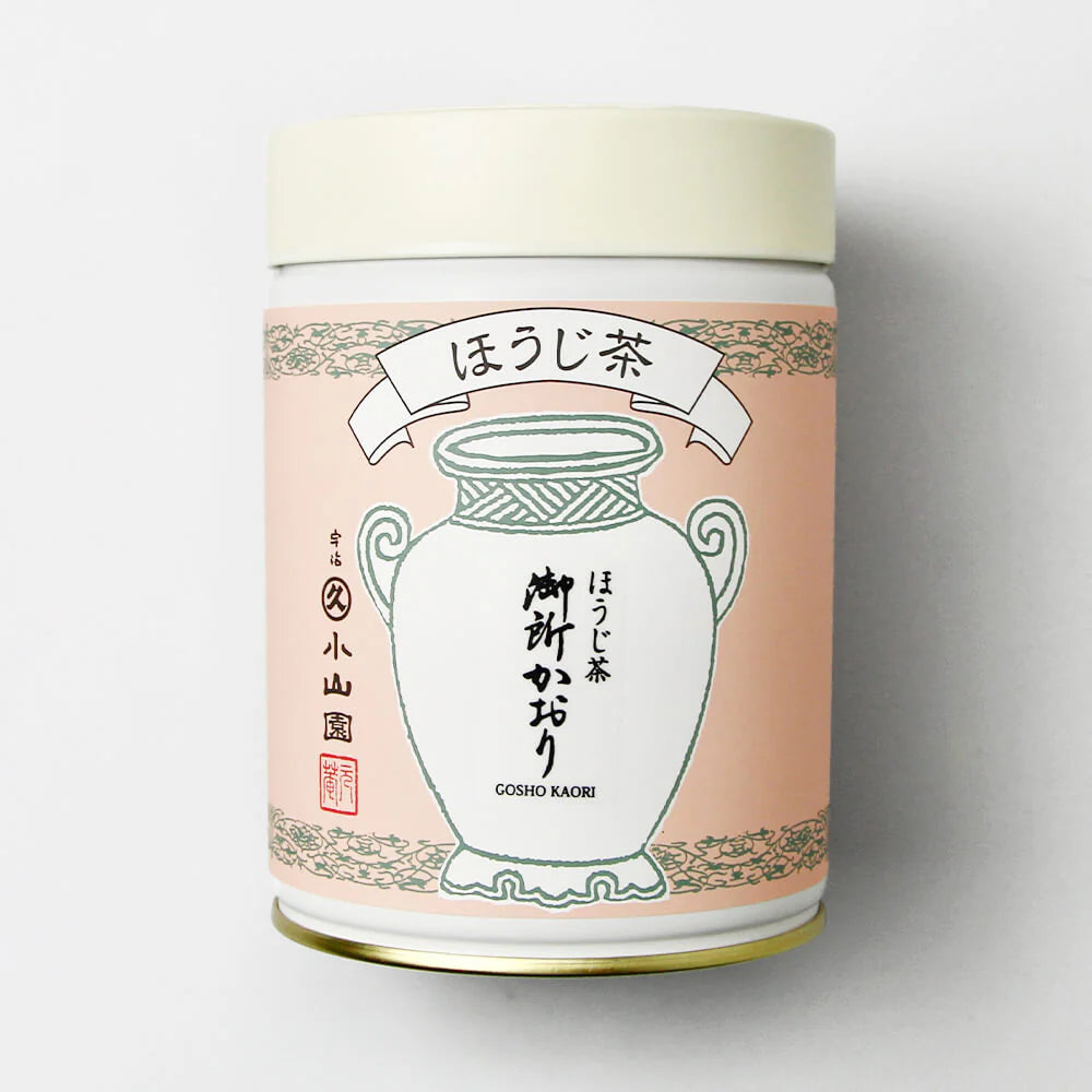 Tea canister with pink label and white vase illustration on a light gray background
