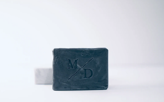 Bar of soap with 'M D' branding on a white background