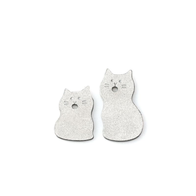 Two cat-shaped ceramic plates on a white background
