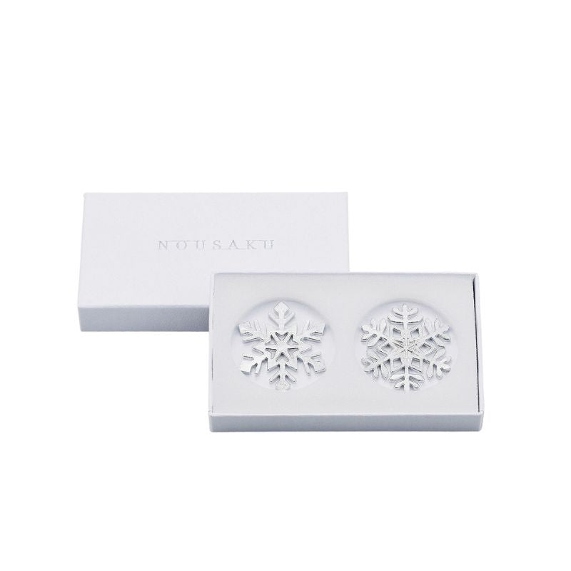 Snowflake earrings in a NANSANU branded box on a white background