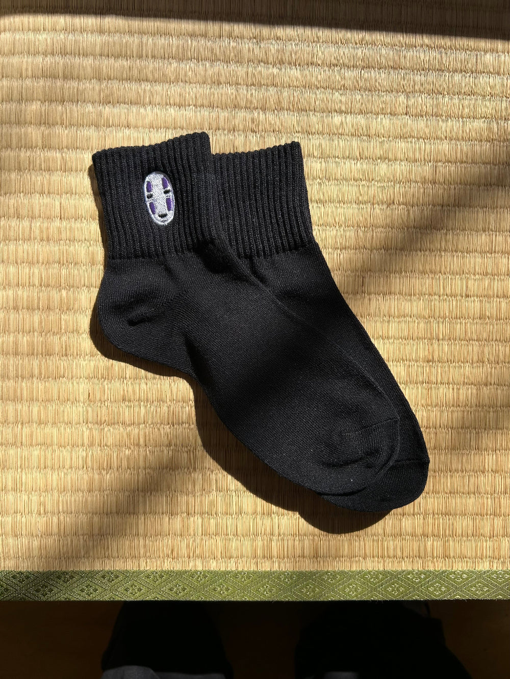Black sock with a no face charactor on a socks