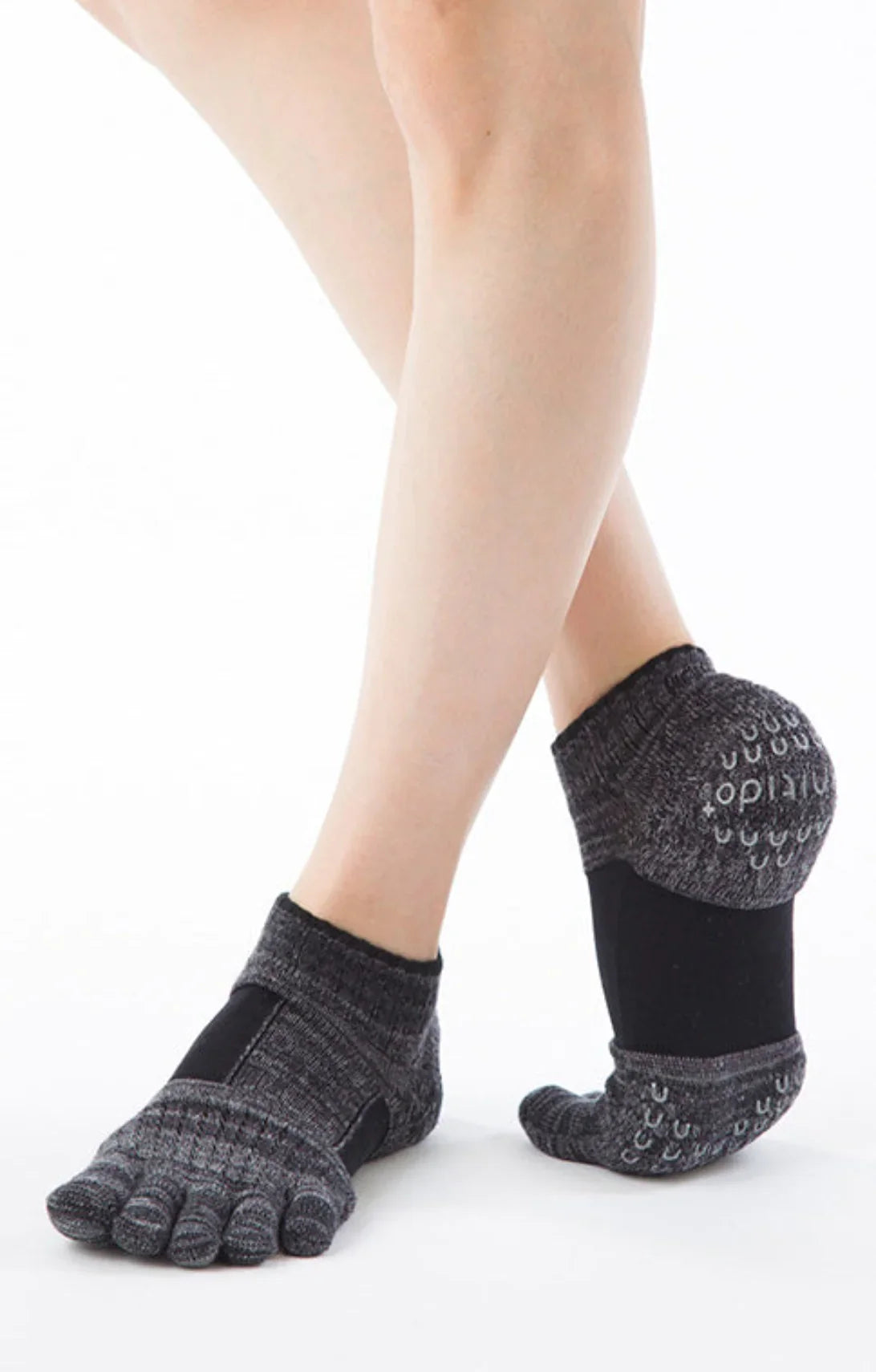 Legs wearing Socks with the product name Arch Support Grip Toe Socks With Power Pads by Knitido plus in Black color.