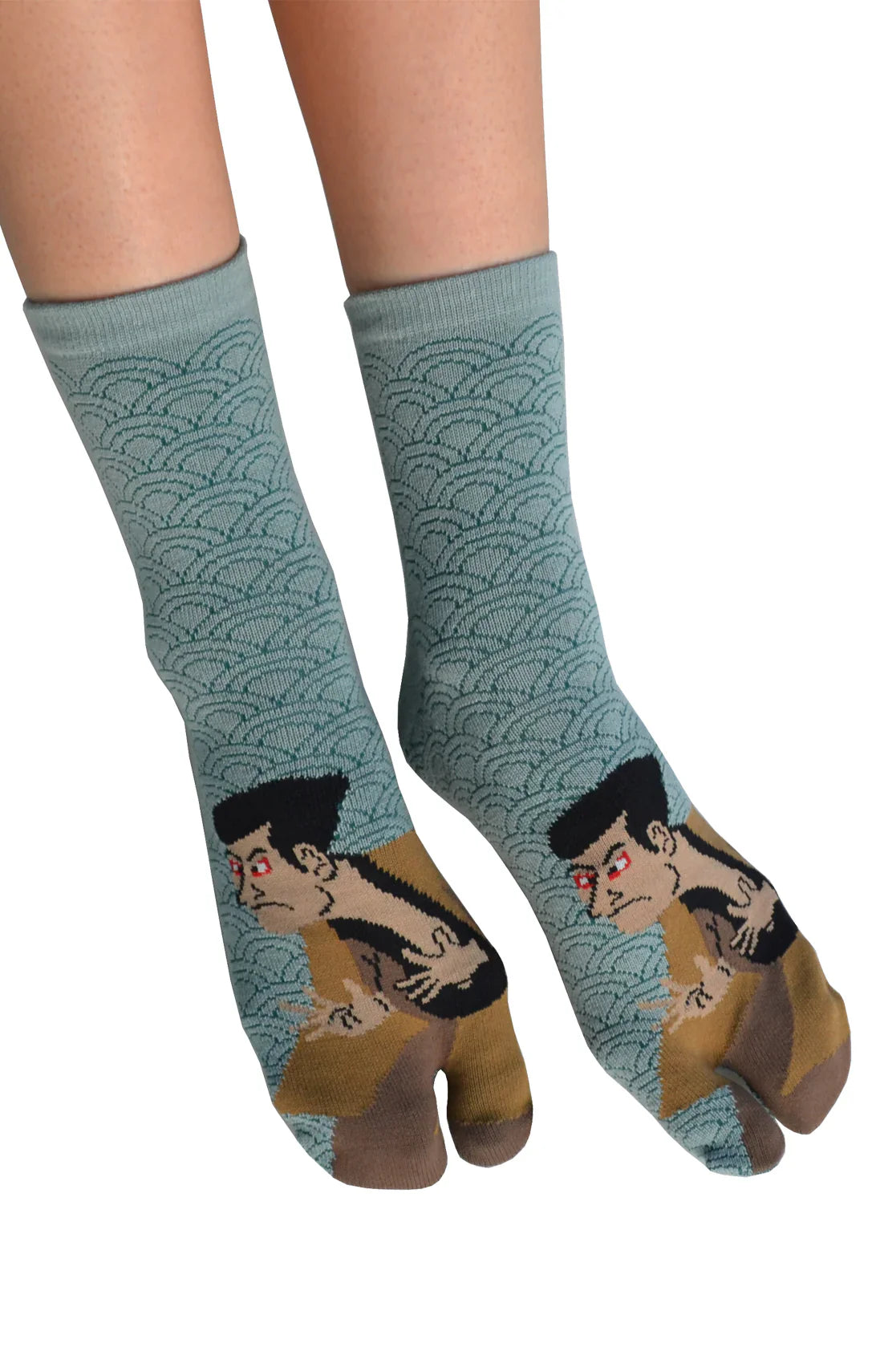 A woman is wearing KABUKI TABI TOE SOCKS Green, a product name inspired by Japanese Kabuki by NINJA SOCKS