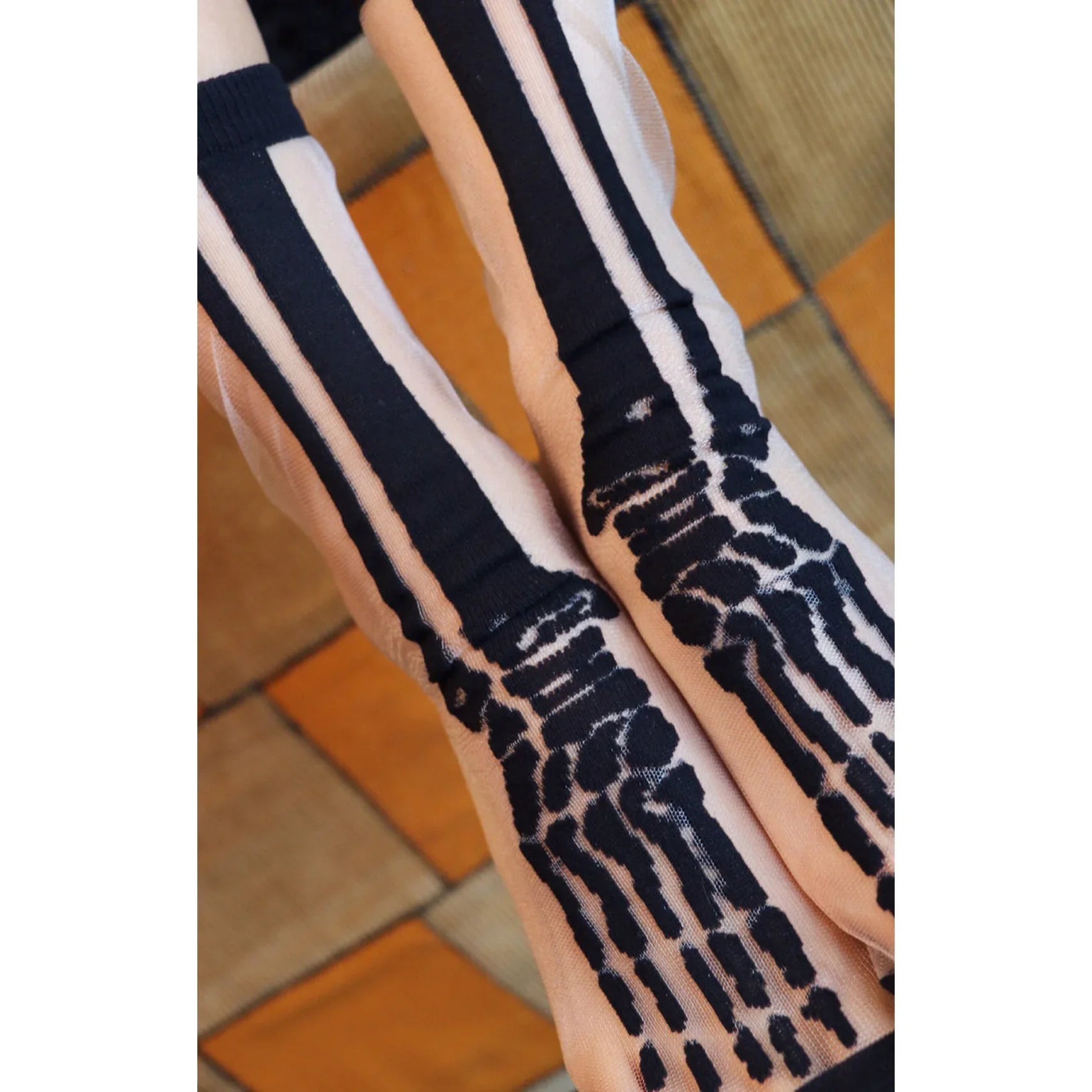 Close-up photo of Tabbisocks' product name CLEAR SKELETON SHEER HALLOWEEN SOCKS