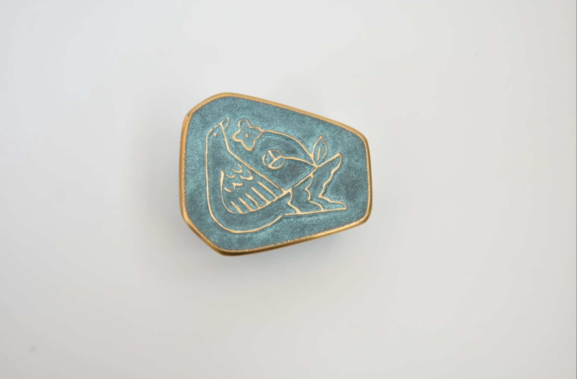 Hexagonal blue coin with gold border and design on a white background