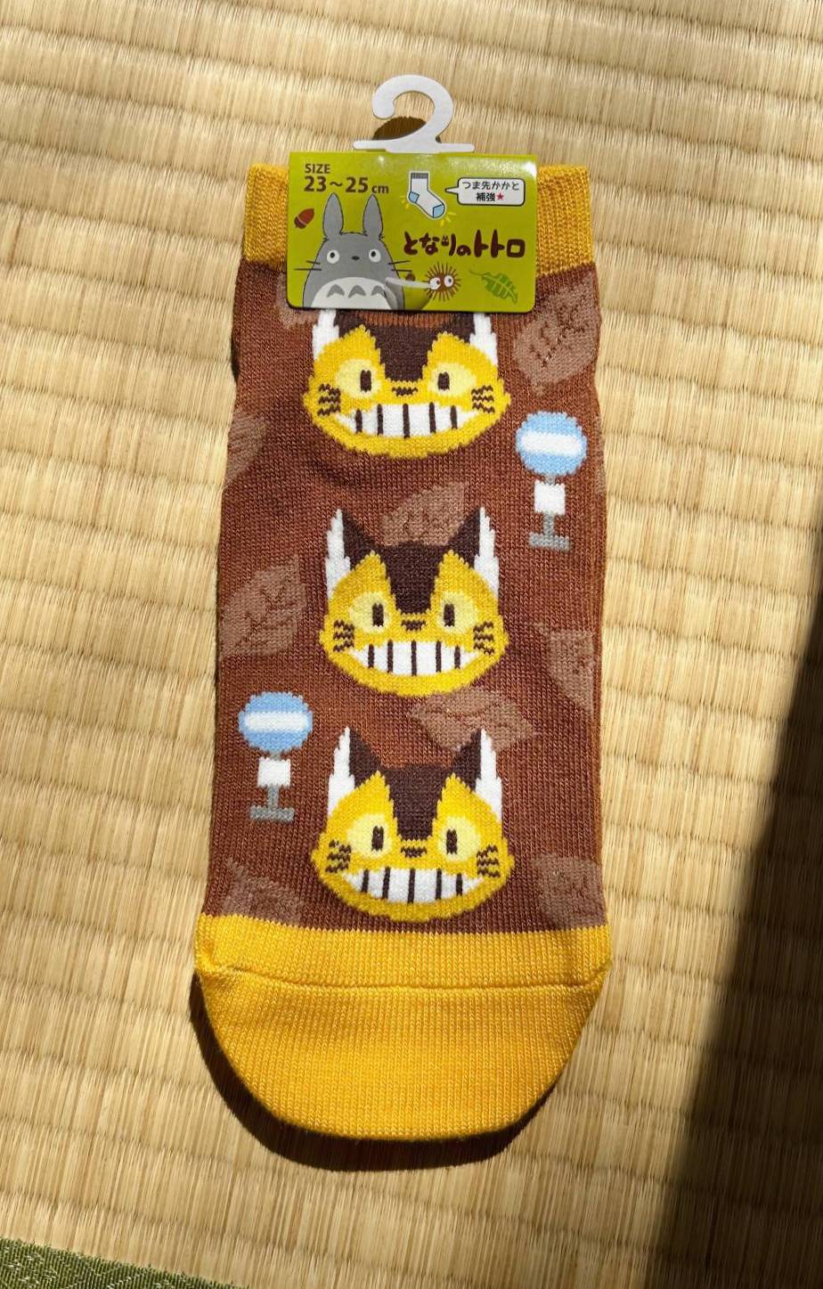 Cartoon character socks with a tag on a woven surface