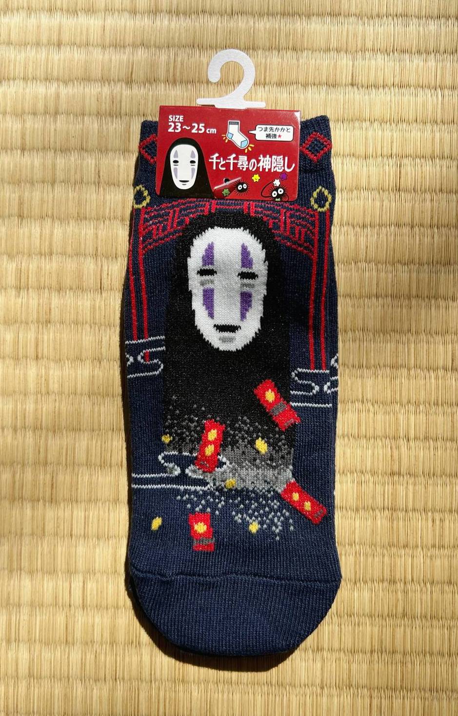 Pair of socks with a character design on a wooden surface